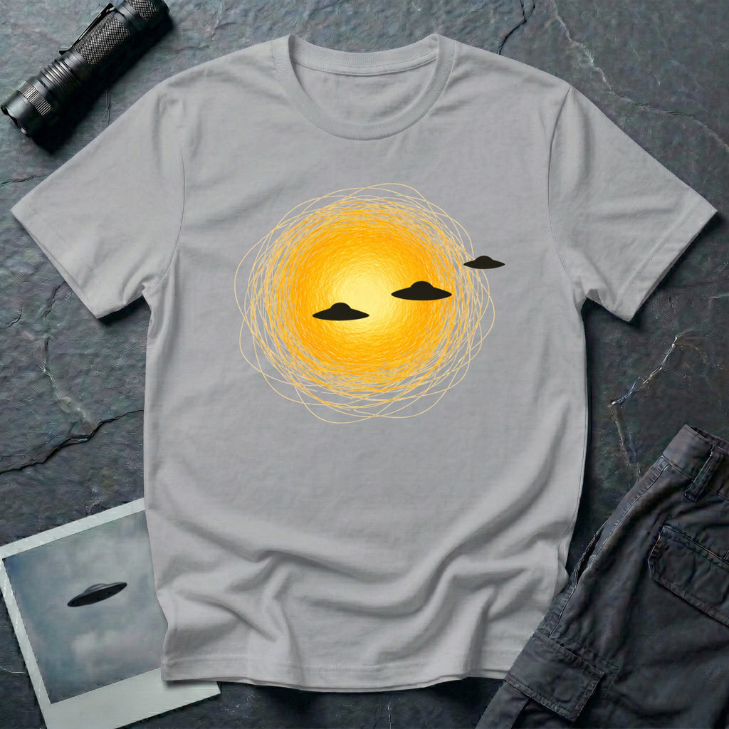 Solar Fly-by artistic UFO t-shirt — three black flying saucers passing across a glowing sun on grey unisex cotton tee