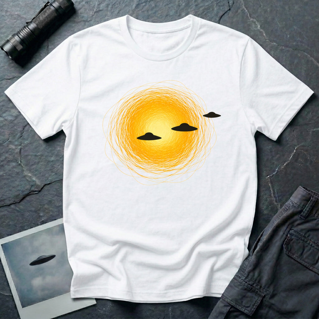 Solar Fly-by artistic UFO t-shirt — three black flying saucers passing across a glowing sun on white unisex cotton tee