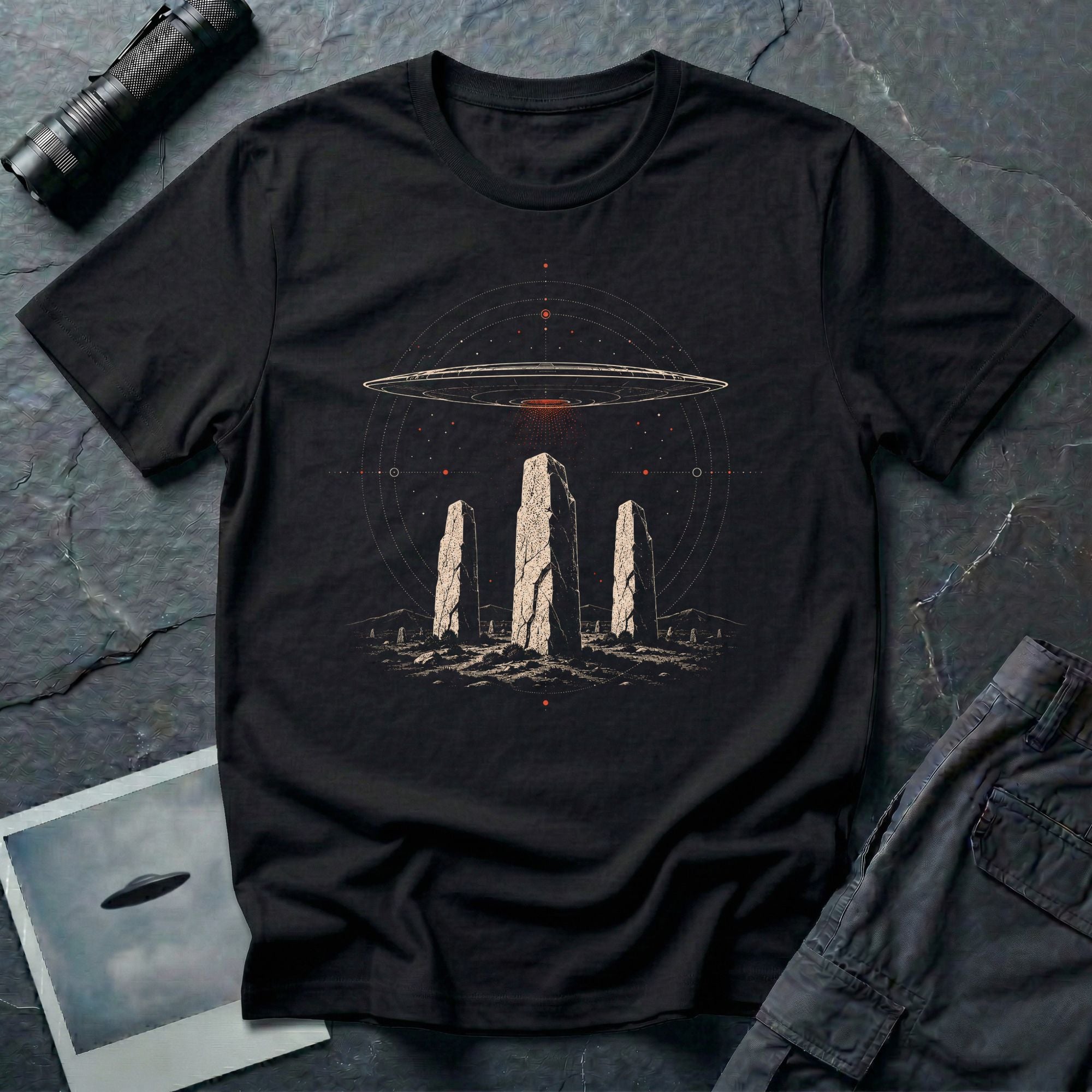 Black UFO t-shirt with saucer hovering above ancient standing stones and orbital sky design