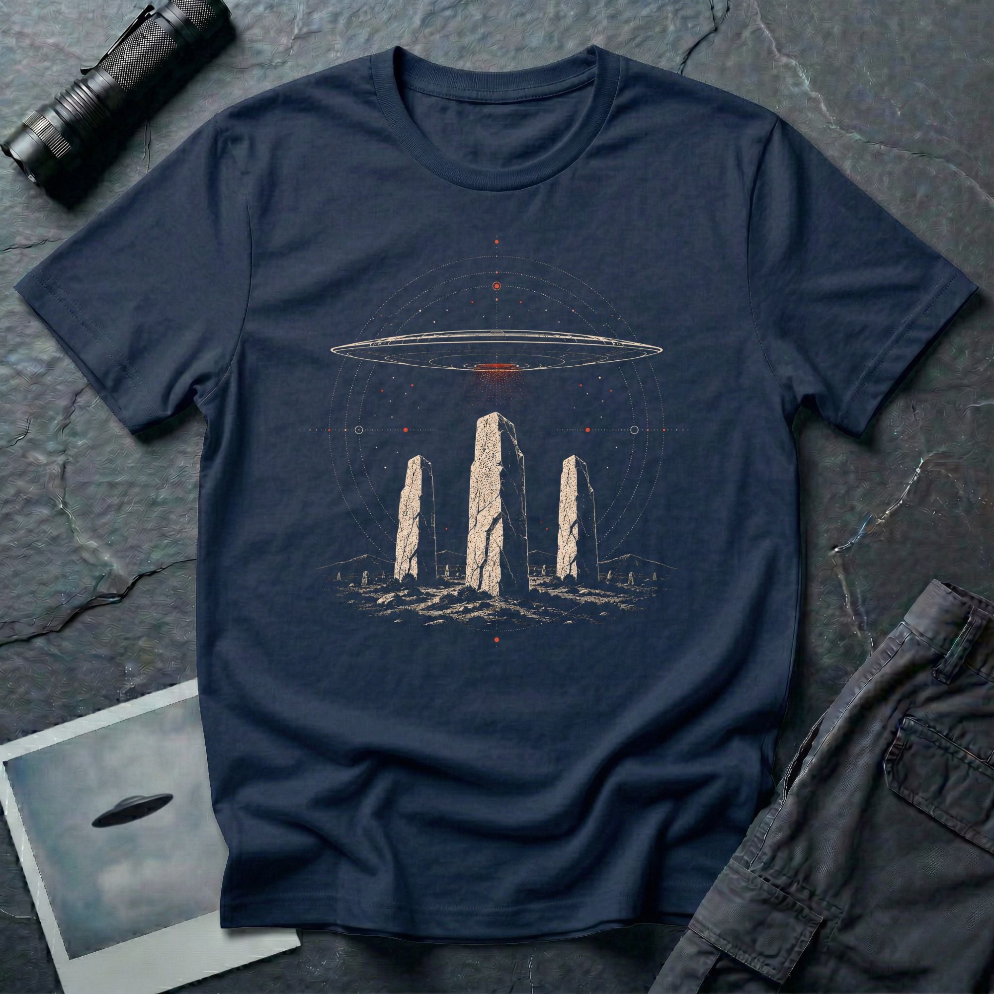 Navy blue UFO t-shirt with saucer hovering above ancient standing stones and orbital sky design