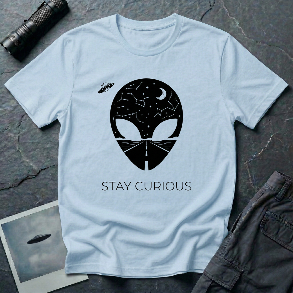Stay Curious curious alien t-shirt — alien silhouette filled with starry sky above and open highway below with "Stay Curious" on light blue cotton tee