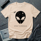 Stay Curious curious alien t-shirt — alien silhouette filled with starry sky above and open highway below with "Stay Curious" on natural cotton tee