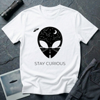 Stay Curious curious alien t-shirt — alien silhouette filled with starry sky above and open highway below with "Stay Curious" on white cotton tee