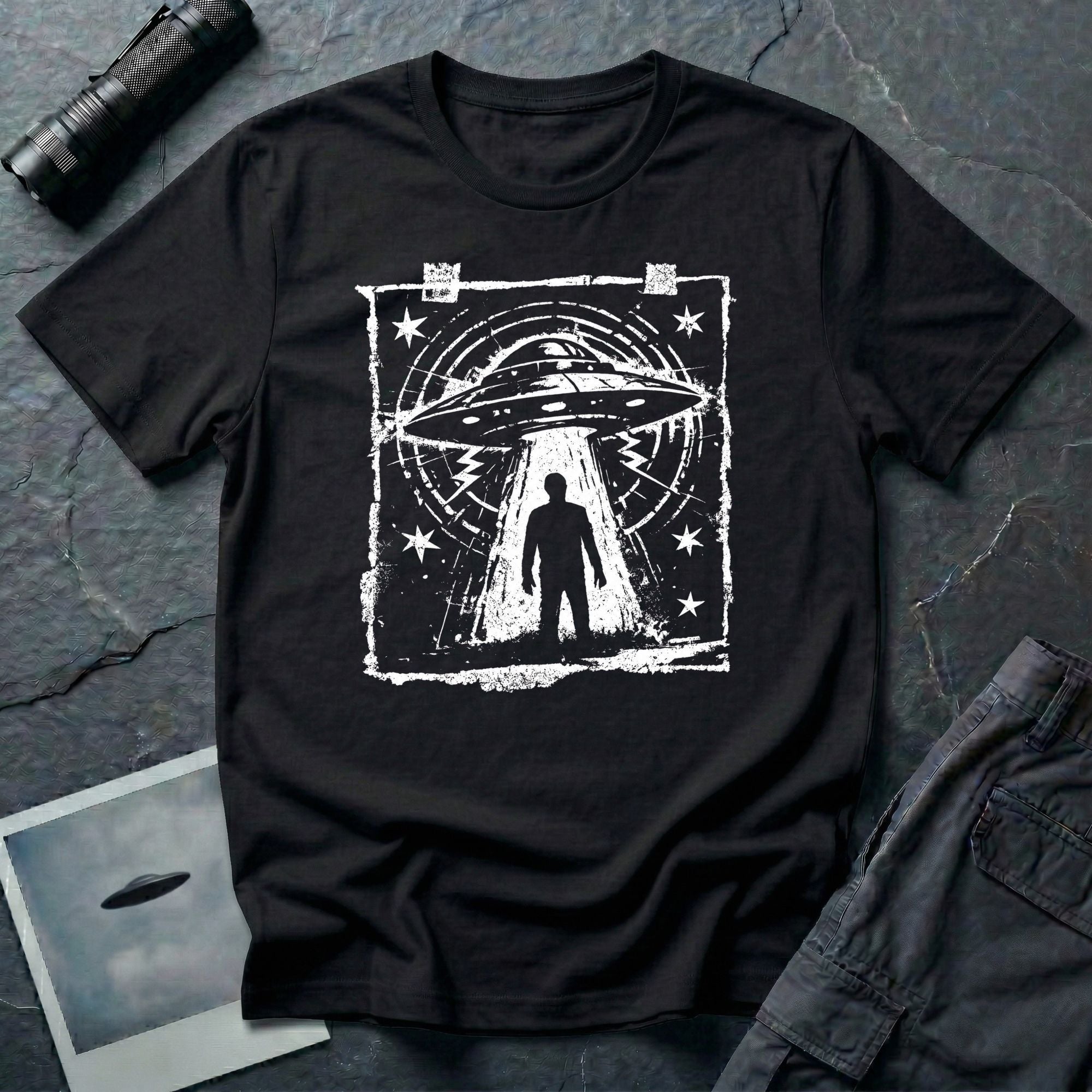 Black UFO t-shirt in styled as a distressed street flyer with saucer tractor beam and human silhouette