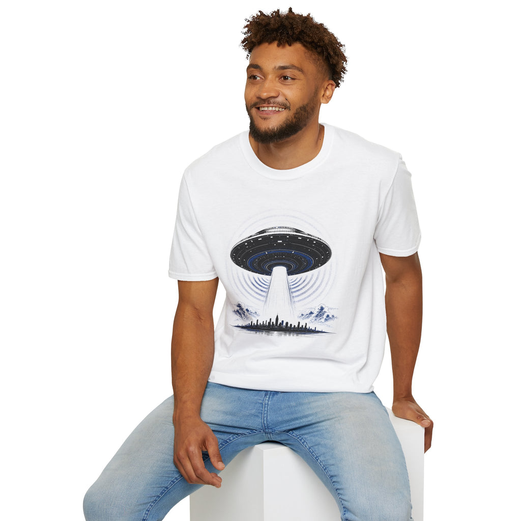 Man wearing white UFO t-shirt with massive mothership beaming light over city skyline at night