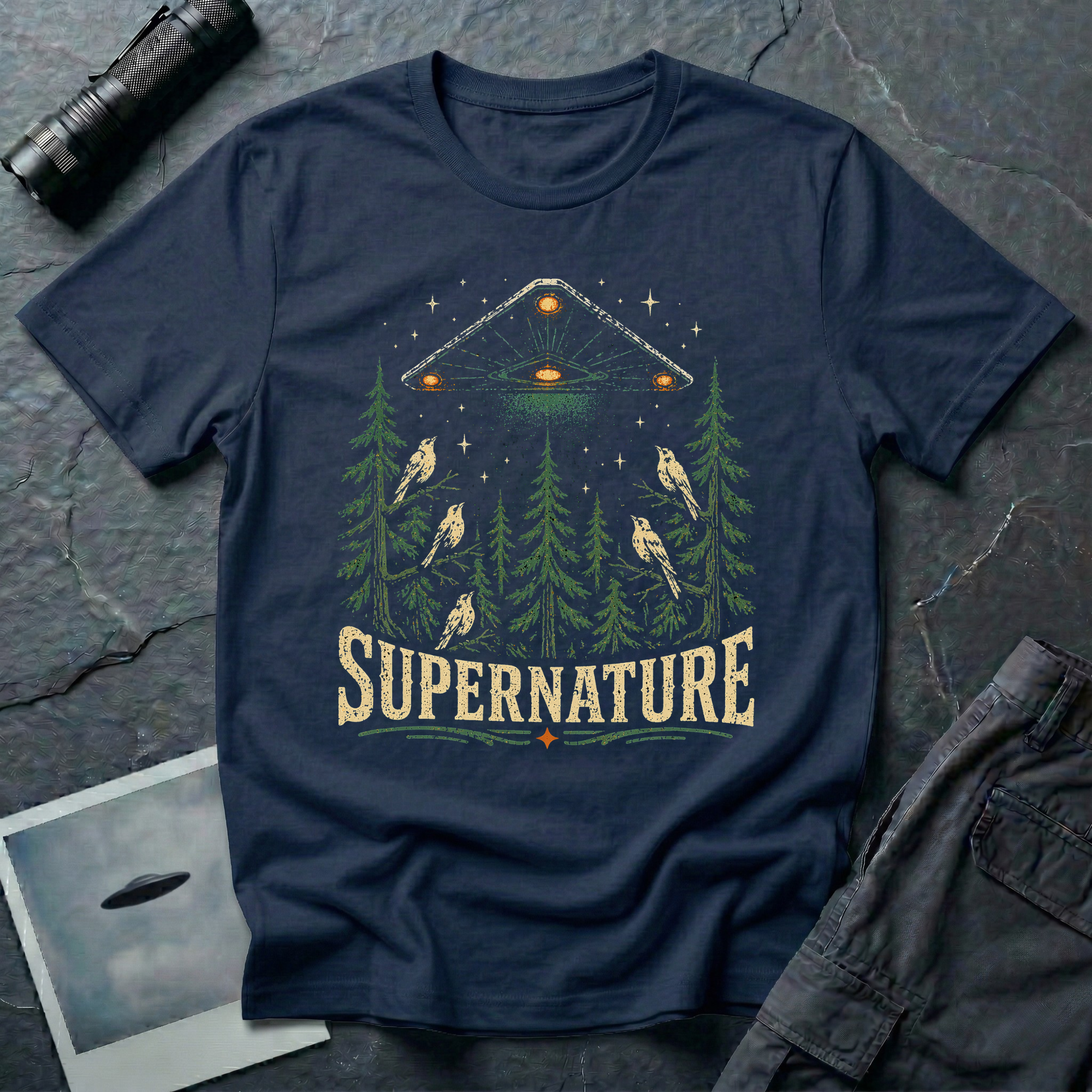 Supernature black triangle UFO t-shirt — triangle craft hovering over pine forest with birds on navy unisex cotton tee