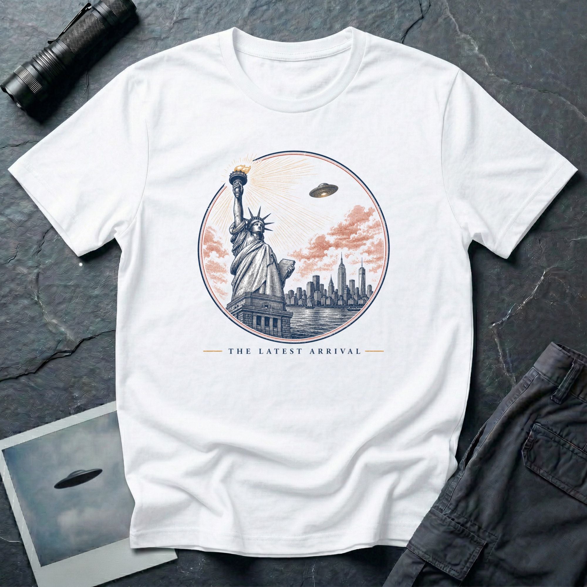 The Latest Arrival UFO t-shirt with Statue of Liberty greeting a descending saucer in engraved style, white tee