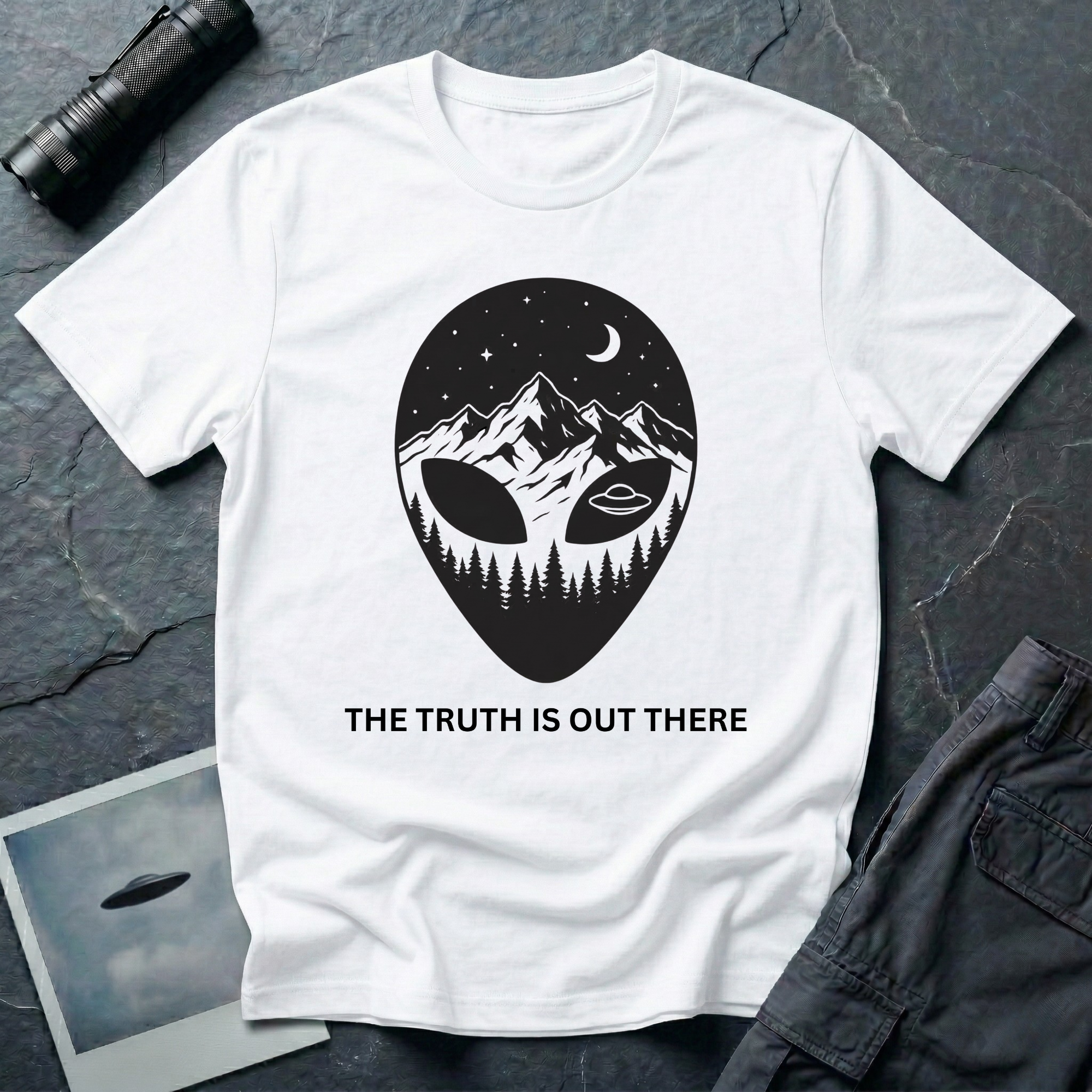 The Truth Is Out There alien head t-shirt — alien silhouette filled with mountains, pine forest and flying saucer on white cotton tee