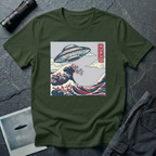 The Wave Japanese woodblock UFO t-shirt — flying saucer above Hokusai-style cresting wave in indigo and red on green cotton tee