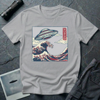 The Wave Japanese woodblock UFO t-shirt — flying saucer above Hokusai-style cresting wave in indigo and red on grey cotton tee