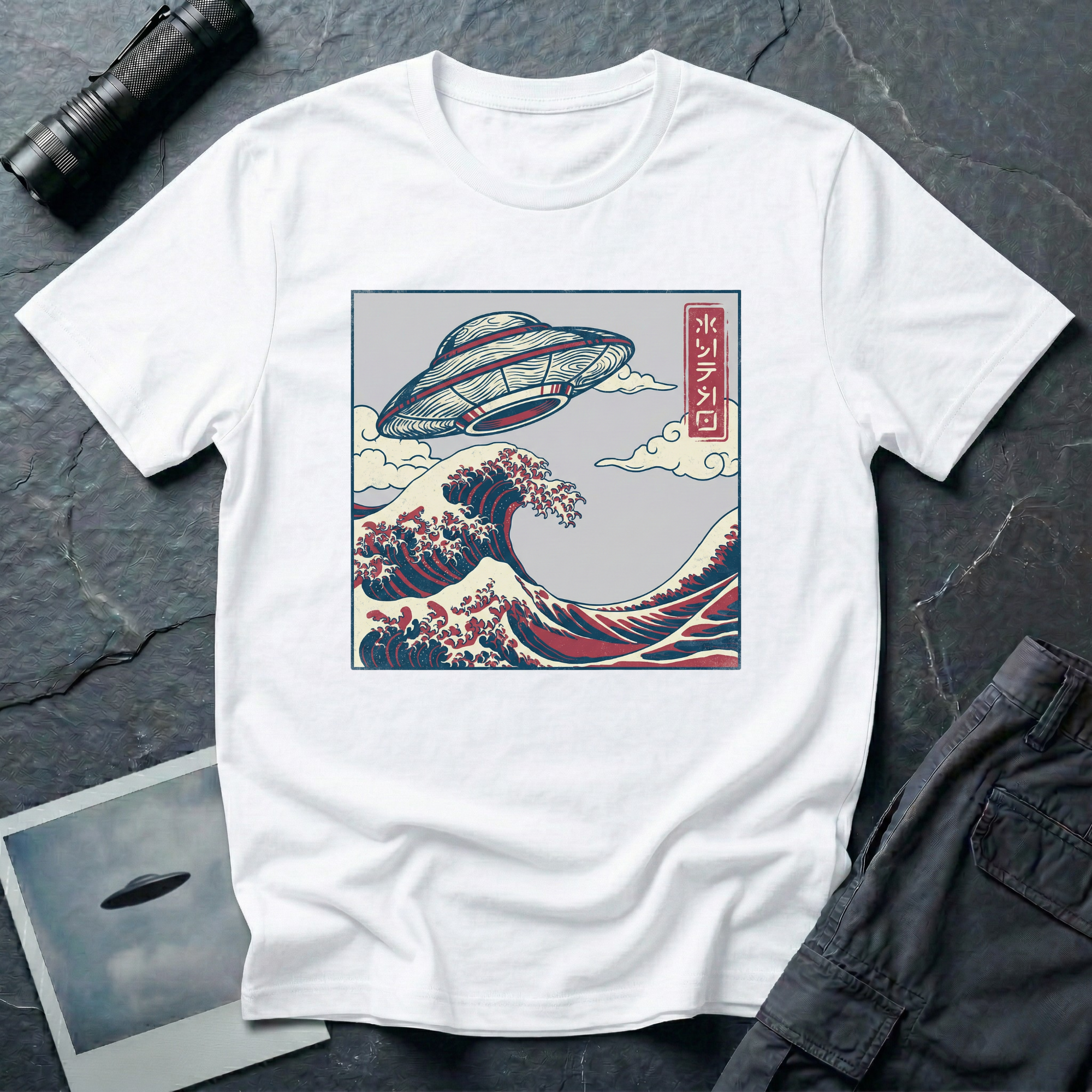 The Wave Japanese woodblock UFO t-shirt — flying saucer above Hokusai-style cresting wave in indigo and red on white cotton tee
