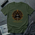 Military green UFO t-shirt with a flying saucer inside an upward-pointing triangle portal with perspective grid, crescent moons, and compass frame in gold and black with the word THRESHOLD