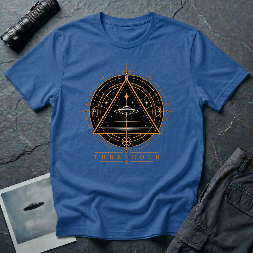 Royal blue UFO t-shirt with a flying saucer inside an upward-pointing triangle portal with perspective grid, crescent moons, and compass frame in gold and black with the word THRESHOLD