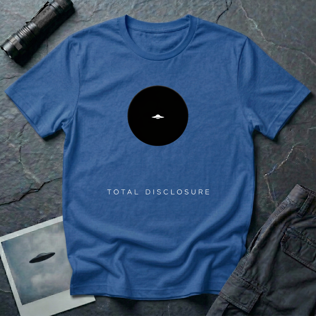 Total Disclosure conceptual UFO t-shirt — small black circle with tiny saucer and "total disclosure" caption on royal blue cotton tee