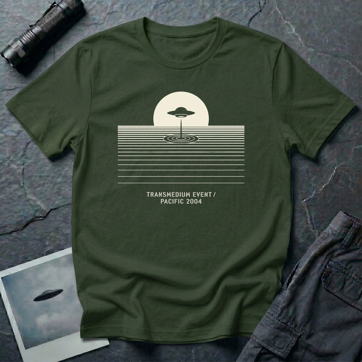 T-shirt with UFO above rippling ocean horizon lines and Transmedium Event Pacific 2004 caption, military green