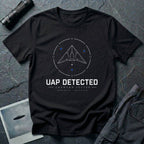 Black t-shirt with geometric angular UAP inside circular radar targeting reticle with UAP DETECTED UNKNOWN VECTOR text and GPS coordinates in white and blue linework