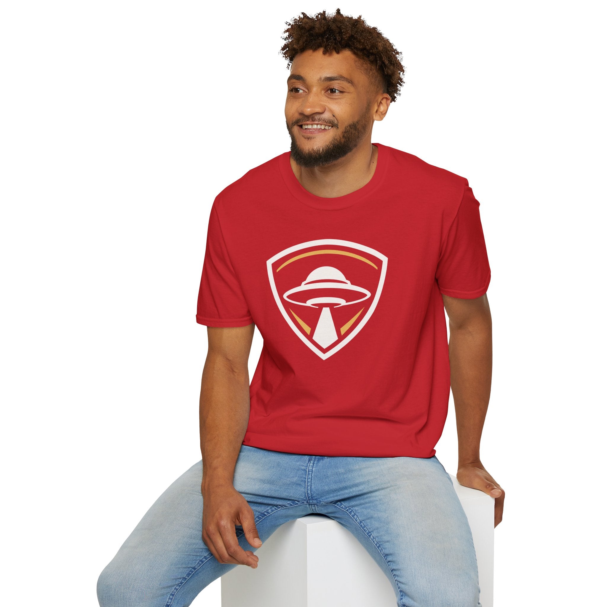 Man wearing red UFO insignia t-shirt with gold and cream crest emblem and classic saucer beaming light
