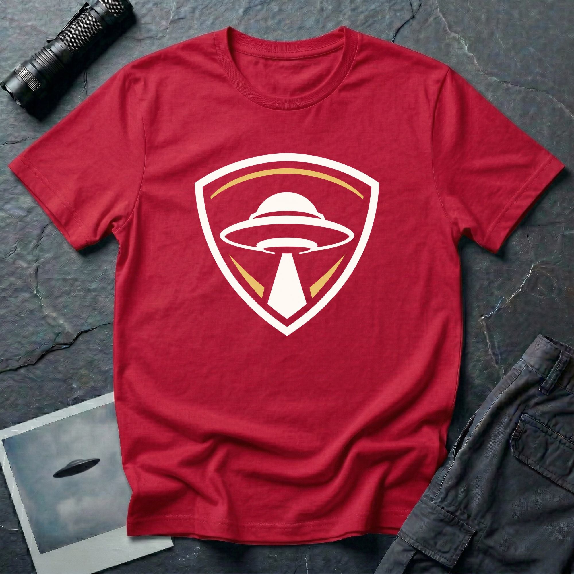 UFO insignia red t-shirt with gold and cream crest emblem and classic saucer beaming light
