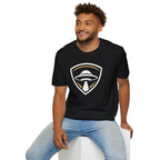 Man wearing black UFO insignia t-shirt with gold and cream crest emblem and classic saucer beaming light