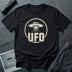 Black retro UFO t-shirt with a distressed circle containing a flying saucer with tractor beam and bold block letters spelling UFO in white