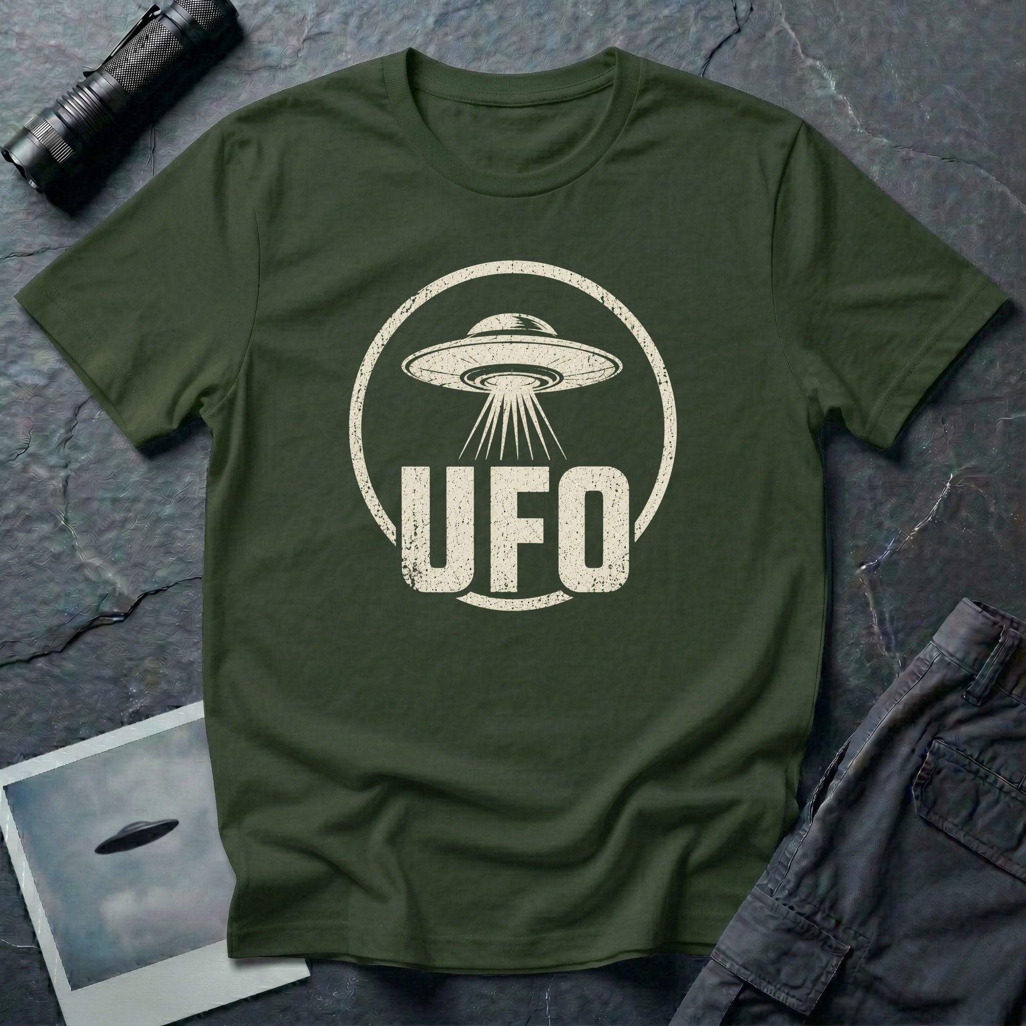 Military green retro UFO t-shirt with a distressed circle containing a flying saucer with tractor beam and bold block letters spelling UFO in white