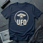 Navy blue retro UFO t-shirt with a distressed circle containing a flying saucer with tractor beam and bold block letters spelling UFO in white