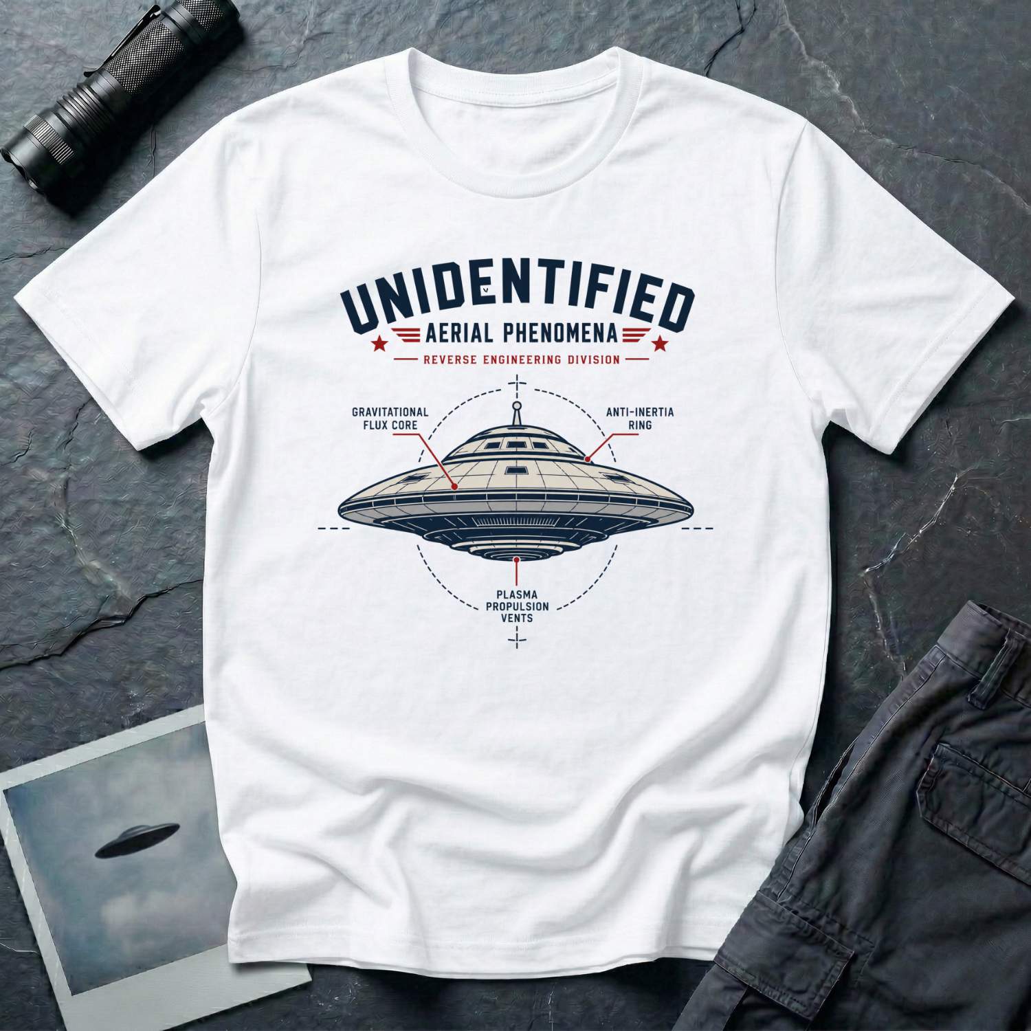 White t-shirt with military-style UAP Reverse Engineering Division patch featuring an annotated saucer diagram with gravitational flux core anti-inertia ring and plasma propulsion vents callouts