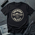 Black retro UFO t-shirt with a distressed circular badge showing a flying saucer with speed lines and the words UNKNOWN OBJECT in white