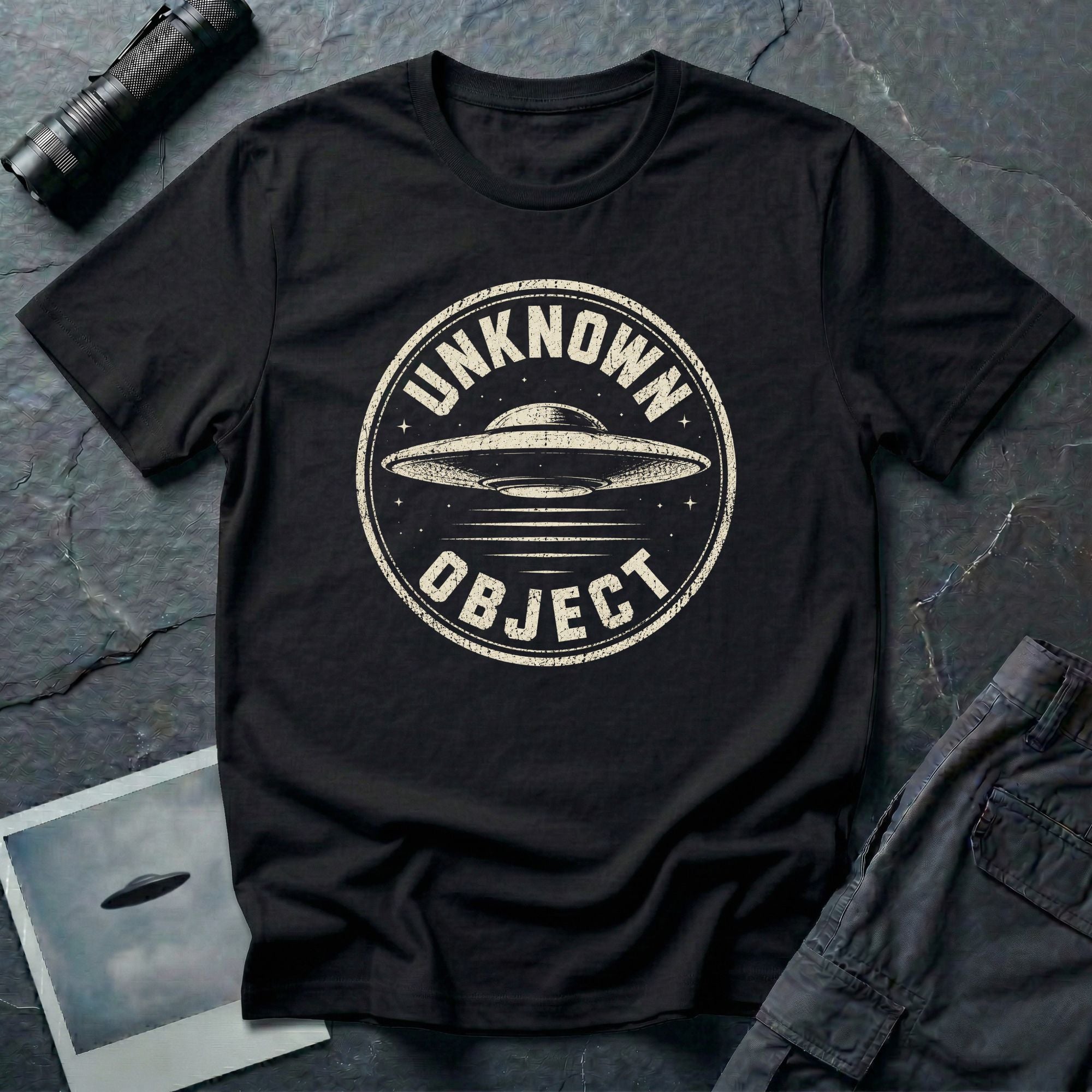 Black retro UFO t-shirt with a distressed circular badge showing a flying saucer with speed lines and the words UNKNOWN OBJECT in white