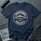 Navy blue retro UFO t-shirt with a distressed circular badge showing a flying saucer with speed lines and the words UNKNOWN OBJECT in white
