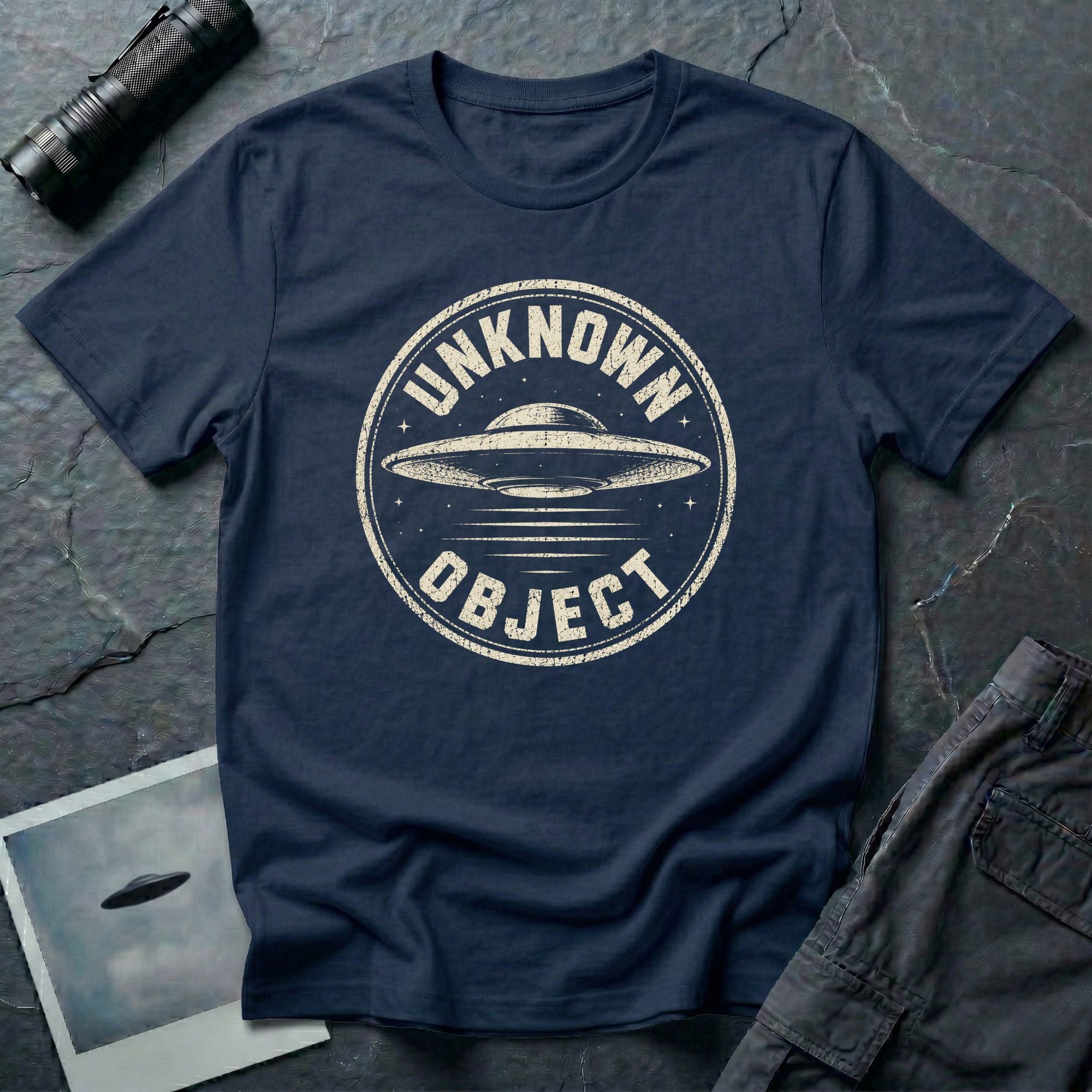 Navy blue retro UFO t-shirt with a distressed circular badge showing a flying saucer with speed lines and the words UNKNOWN OBJECT in white