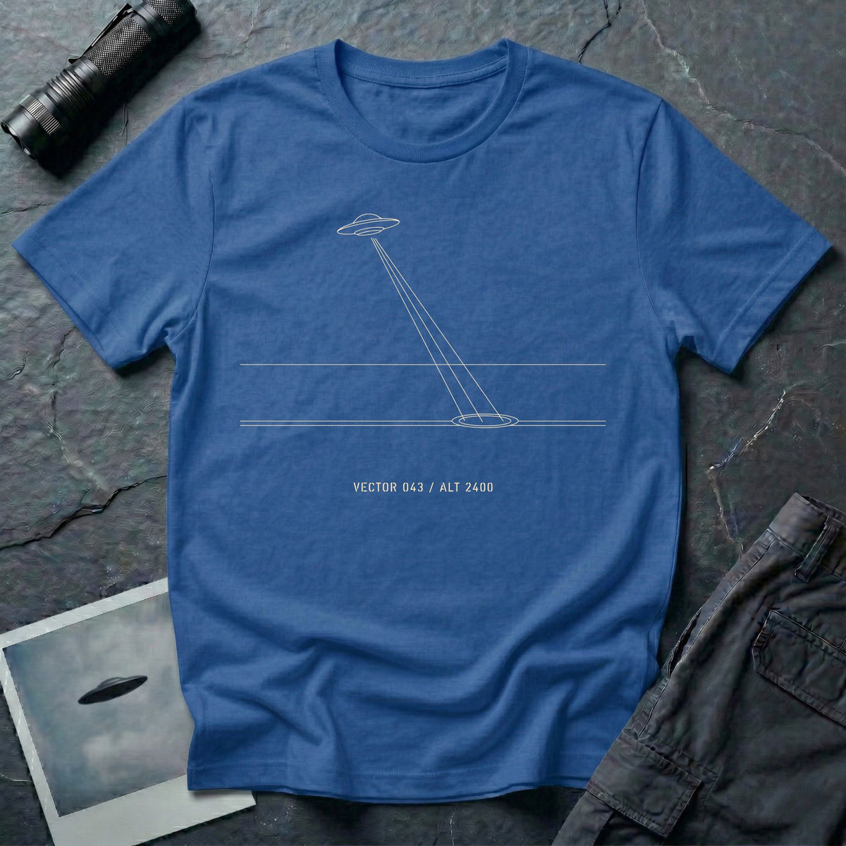 Royal blue t-shirt with minimalist line art UFO beam hitting ground and Vector 043 Alt 2400 caption