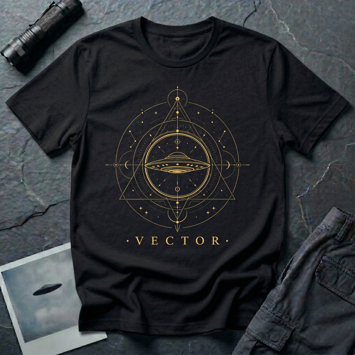 Black UFO t-shirt with a flying saucer inside an upward-pointing sacred geometry triangle with compass points and crescent moons in gold with the word VECTOR beneath