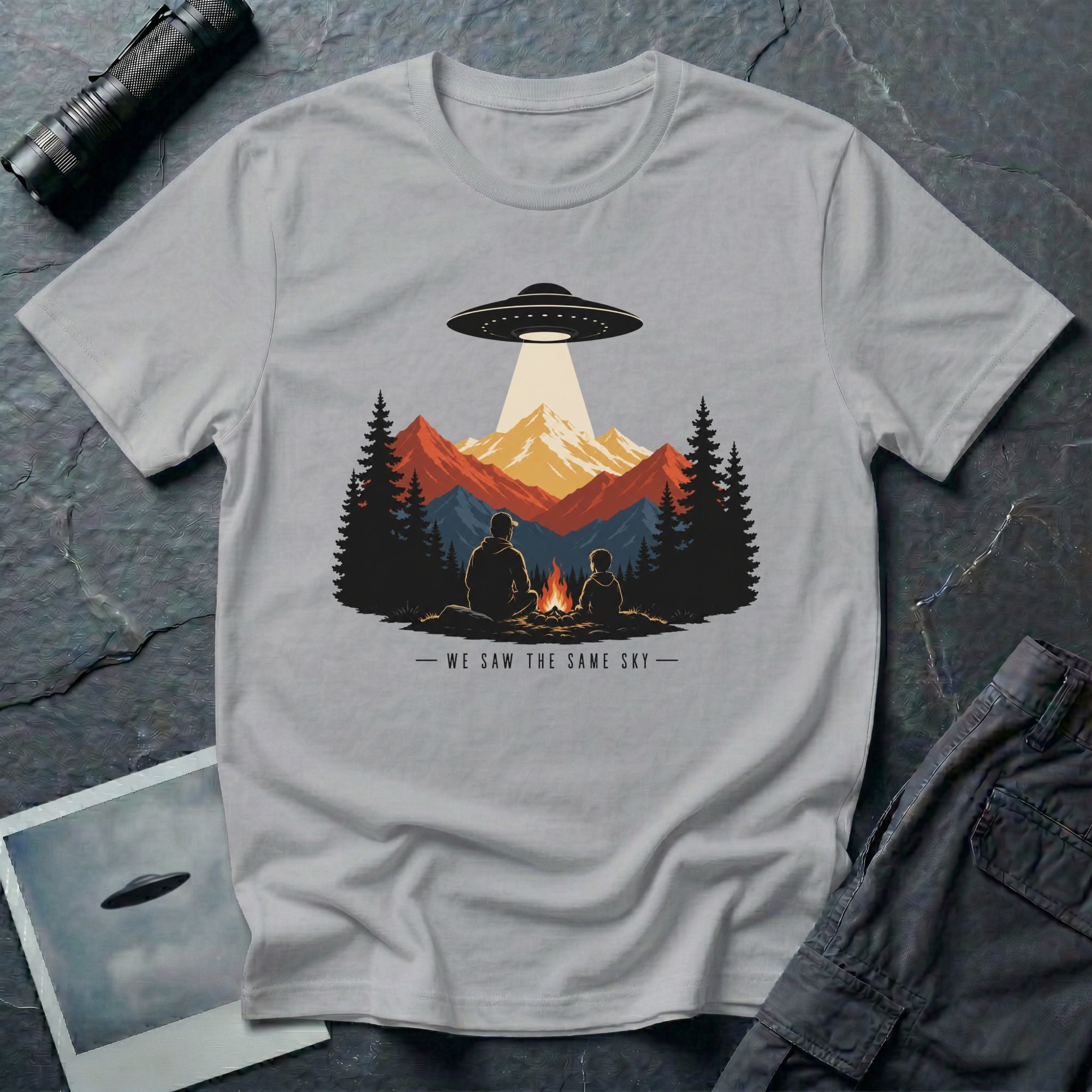 We Saw the Same Sky UFO t-shirt with father and child at campfire watching saucer over mountains, grey