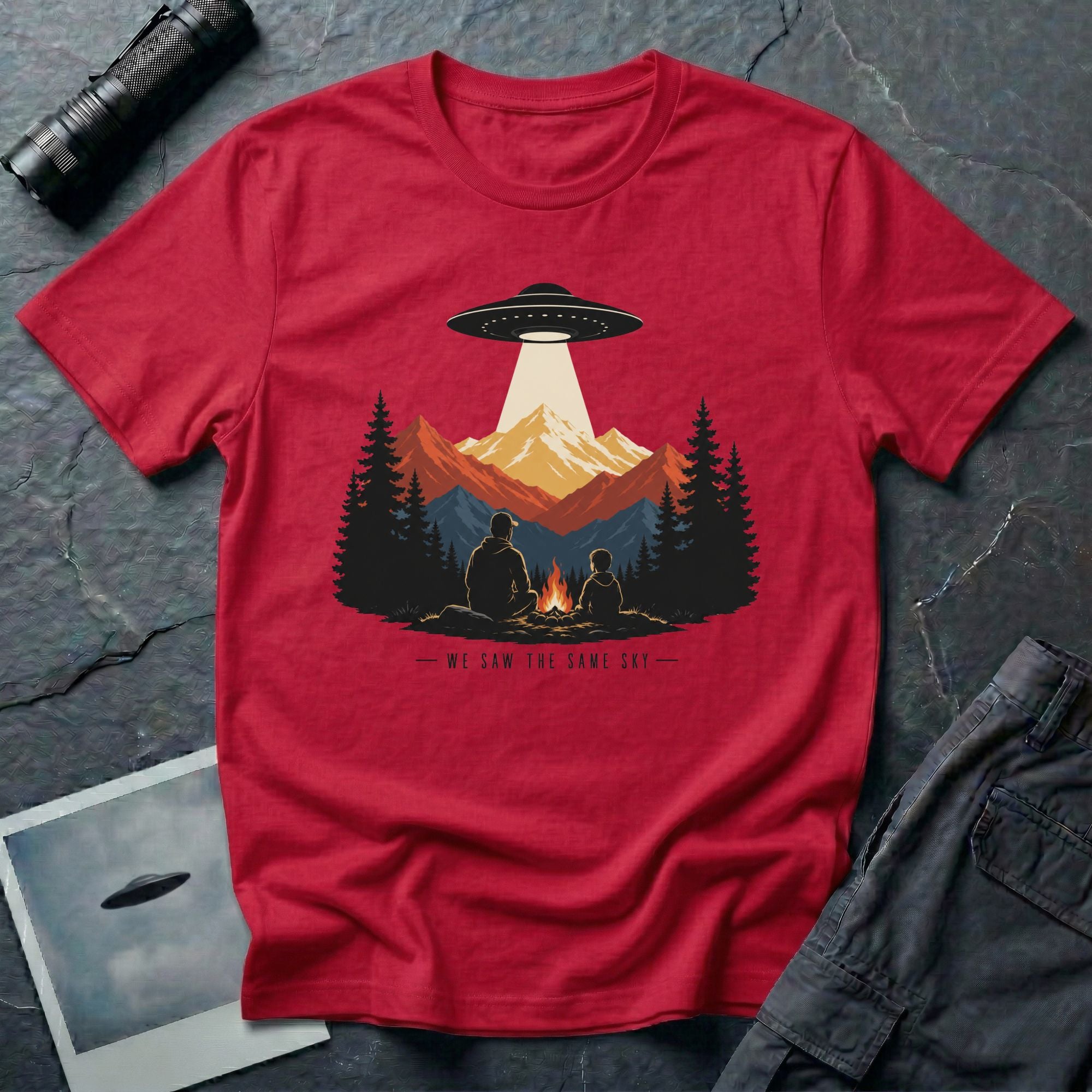 We Saw the Same Sky UFO t-shirt with father and child at campfire watching saucer over mountains, red