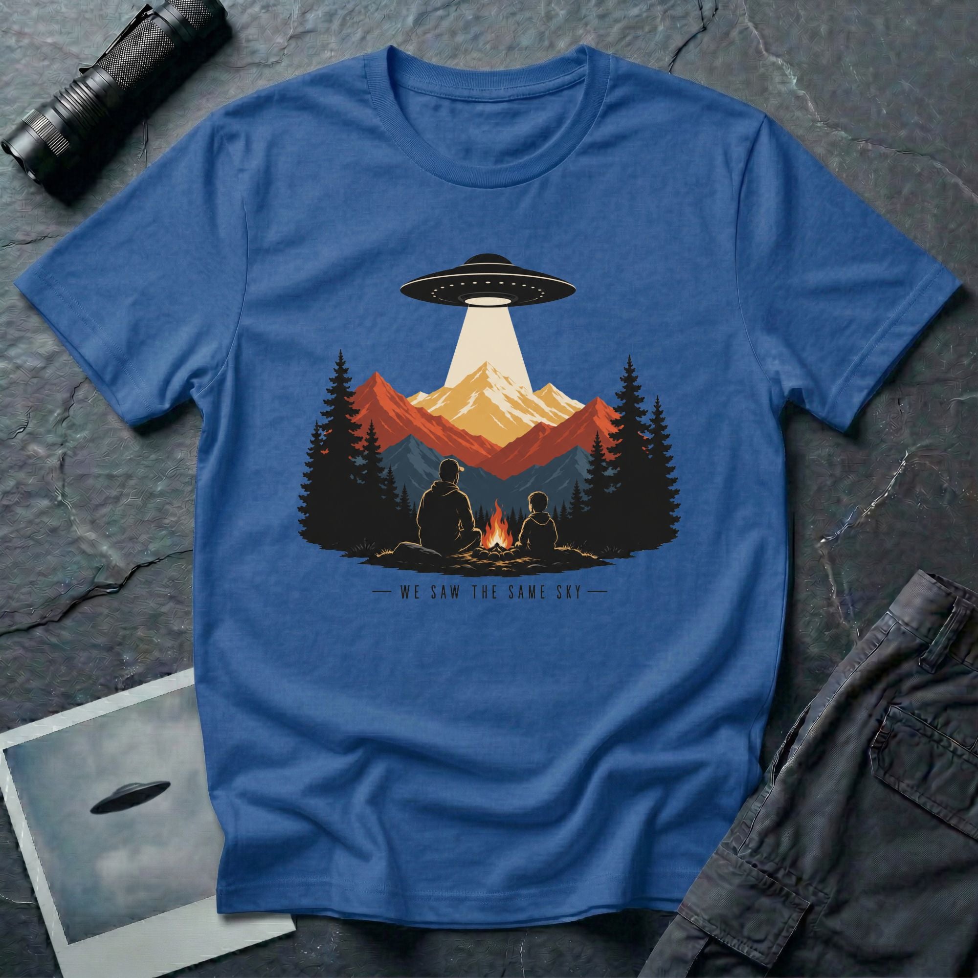 We Saw the Same Sky UFO t-shirt with father and child at campfire watching saucer over mountains, royal blue