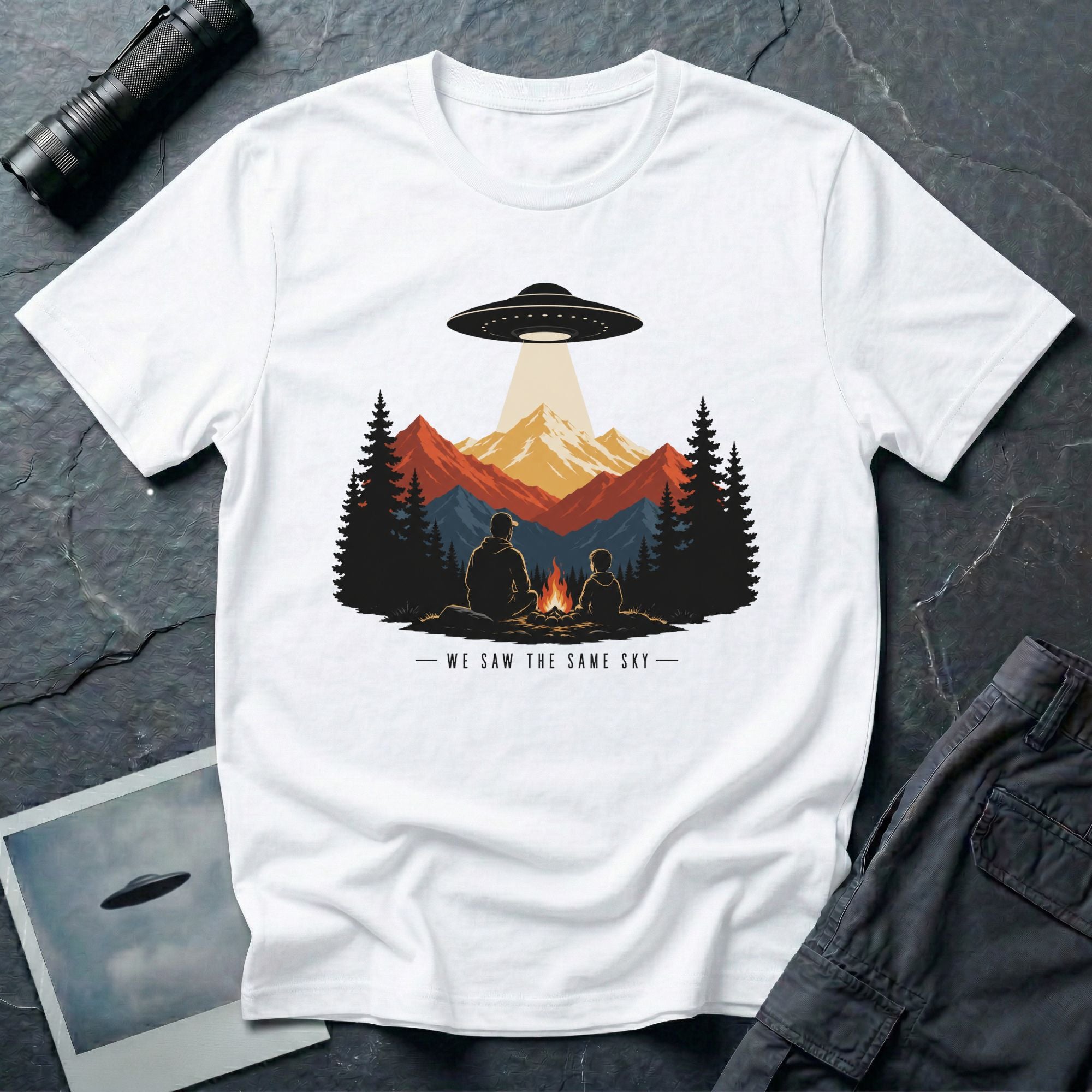 We Saw the Same Sky UFO t-shirt with father and child at campfire watching saucer over mountains, white
