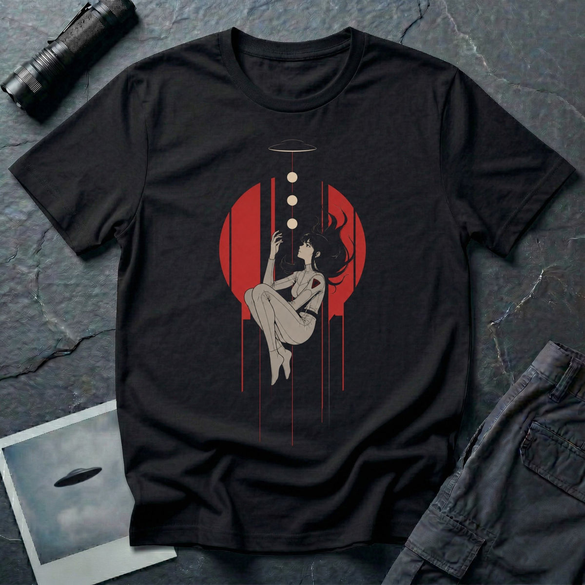 Black t-shirt with Japanese anime style illustrated figure levitating beneath a UFO and three light orbs against a red circle